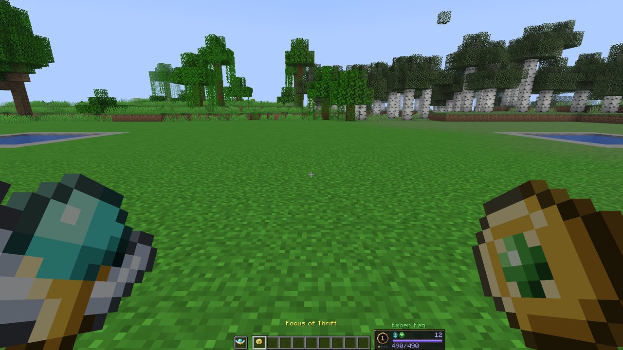 First-person view holding a staff in one hand and a gold Focus of Thrift with a green gem in the other